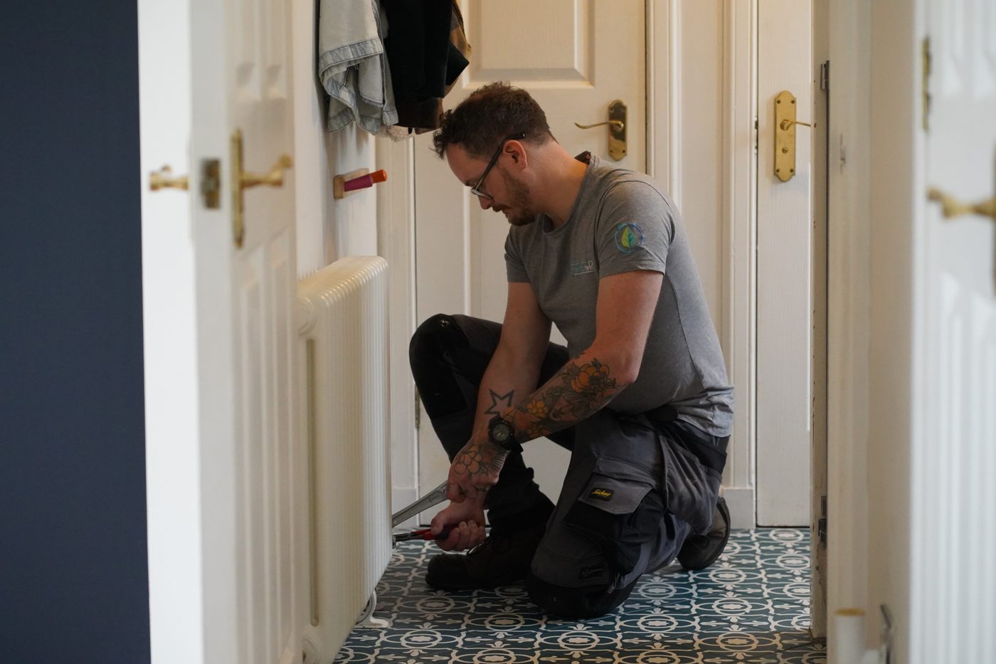 Thermatek Heating engineer installing an air source heat pump system